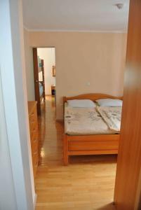 a bedroom with a bed and a wooden floor at Vila Park in Rogaška Slatina