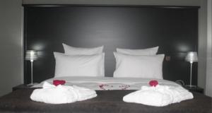 Ένα ή περισσότερα κρεβάτια σε δωμάτιο στο Ubay Hotel