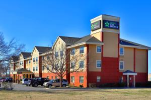a hotel building with a sign on top of it at Suburban Studios in Oklahoma City