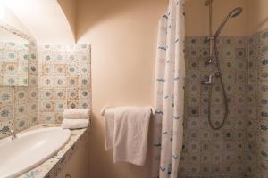a bathroom with a shower and a tub and a sink at Maison coeur de village Ramatuelle in Ramatuelle