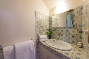 a bathroom with a sink and a mirror at Maison coeur de village Ramatuelle in Ramatuelle +20 photos