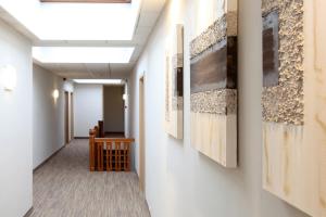 a hallway with paintings on the walls at Ambassador Hotel in De Panne