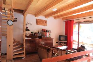 a living room with a table and chairs and a television at Holiday Home Edi in Delnice