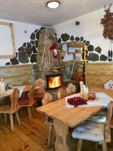 a dining room with a table and a stone fireplace at pension U Jiřího in Ludvíkov