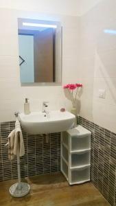 a bathroom with a sink and a mirror at Rosy B&B in Alghero