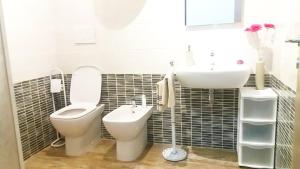 a bathroom with a toilet and a sink at Rosy B&B in Alghero