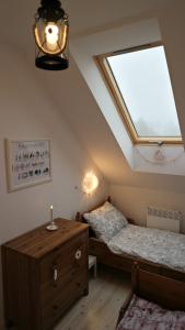 a bedroom with two twin beds and a skylight at Holiday Home Sielanka domek z sauną na Kaszubach in Barkocin