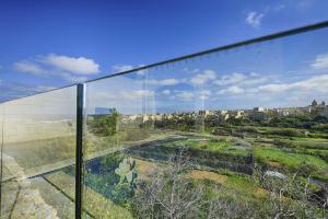 a view of a city from a glass building at Hemda no 3 in Birbuba