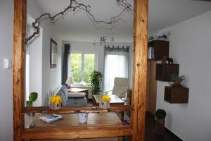 a living room with a table and a couch at FeWo Strohbach in Meißen +11 photos