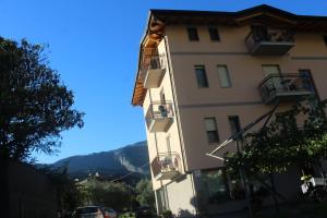 a tall white building with balconies on the side of it at Villa Marina in Nago-Torbole +11 photos