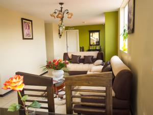 a living room with a couch and a table at Hotel Las Gardenias in Cuenca