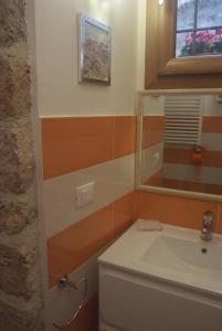 a bathroom with a toilet and a mirror at Piccola corte in Ascoli Piceno