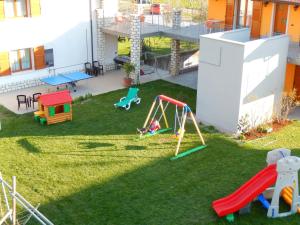 a backyard with a playground with a swing at Agritur Giovanazzi in Arco