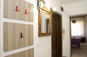 a bathroom with wooden doors and a mirror at Apartment Medical University in Pleven