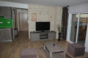a living room with a flat screen tv on a cabinet at Apartmani Ivana in Bjelovar