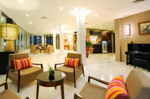 a living room with a couch and chairs and a piano at Kasemsarn Hotel Chanthaburi in Chanthaburi
