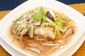a white bowl of soup with meat and vegetables at Kasemsarn Hotel Chanthaburi in Chanthaburi