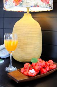 a plate of red peppers next to a glass of orange juice at Kasemsarn Hotel Chanthaburi in Chanthaburi