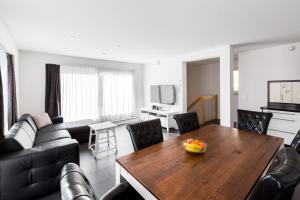 a living room with a table and a couch at Superior Apartment Sarnen in Sarnen