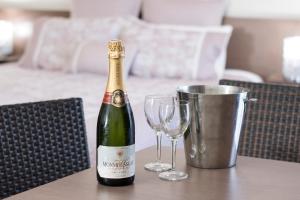 a bottle of champagne and two glasses on a table at The Metropolitan Spring Hill in Brisbane