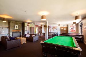 a living room with a pool table in it at Reavers Lodge in Queenstown