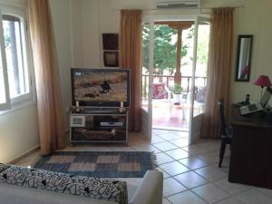 a living room with a flat screen tv and a living room at Beachfront home for 8, Kalifteri Beach, Afissos in Afissos