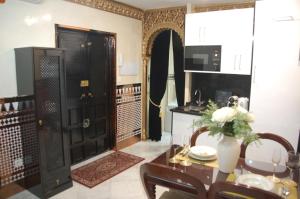 a kitchen with a table and a black door at Luxury Apartment Plus Ultra in Seville