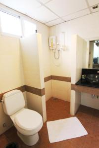 a bathroom with a white toilet and a sink at Bansabai Hostelling International in Bangkok