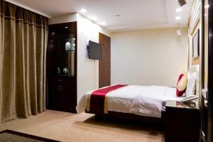 Letto o letti in una camera di New World Hotel