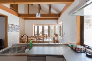 a kitchen with a sink and a counter top at Nozawa House in Nozawa Onsen