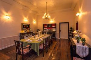 a dining room with a long table with chairs at Ging Tea House in Darjeeling