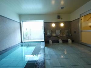 - une salle de bains avec une piscine et 2 toilettes dans l'établissement Hotel Route-Inn Nakatsu Ekimae, à Nakatsu