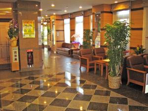 a lobby of a hospital with chairs and a checkerboard floor at Hotel Route-Inn Yukuhashi in Yukuhashi