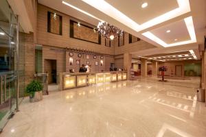a lobby with a dance floor in a building at JP Chennai Hotel in Chennai