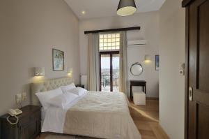a bedroom with a large bed and a large window at Dryades & Orion Hotel in Athens
