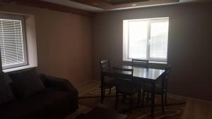 a living room with a table and chairs and a couch at Pestani Apartment in Peštani