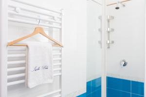 a bathroom with a shower and a towel on a rack at Isola Blu in Taranto +95 photos