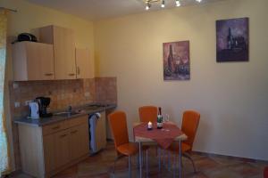 a kitchen with a table and chairs and a kitchen with a sink at Ferienhaus Käpt´n Moritz in Karlshagen