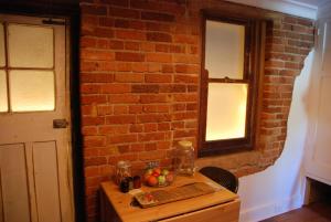 a wooden table with fruit on it in a brick wall at Hillside Cottage Berrima in Berrima +8 photos