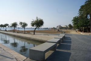 a row of benches next to a body of water at Agi Port de Rosas in Roses
