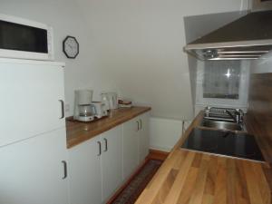 a kitchen with a sink and a counter top at Ferienhaus Gumann in Nuremberg