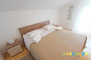 Posteľ alebo postele v izbe v ubytovaní Apartments Šuperba