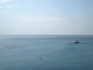 a boat in the middle of a large body of water at Panorama Hotel in Agia Marina Aegina