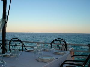 a table on a boat in the ocean at Panorama Hotel in Agia Marina Aegina
