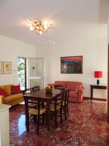 a living room with a table and a couch at Villa Delle Ciliegie in Deiva Marina