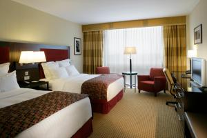سرير أو أسرّة في غرفة في Pillo Hotel & Leisure Club