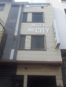 a building with the words hotel m city on it at Hotel M City in Amritsar