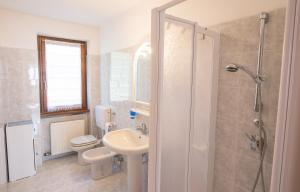 a bathroom with a sink and a toilet and a shower at Casa Lori Green Holiday in Ledro