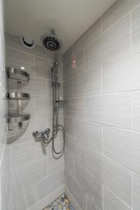 a bathroom with a shower with white tiles at Tignes 301 in Tignes