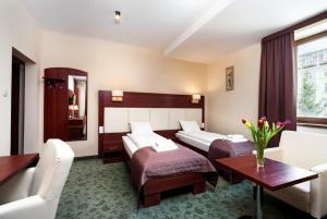 Posteľ alebo postele v izbe v ubytovaní Hotel Młyn + 17 fotografií